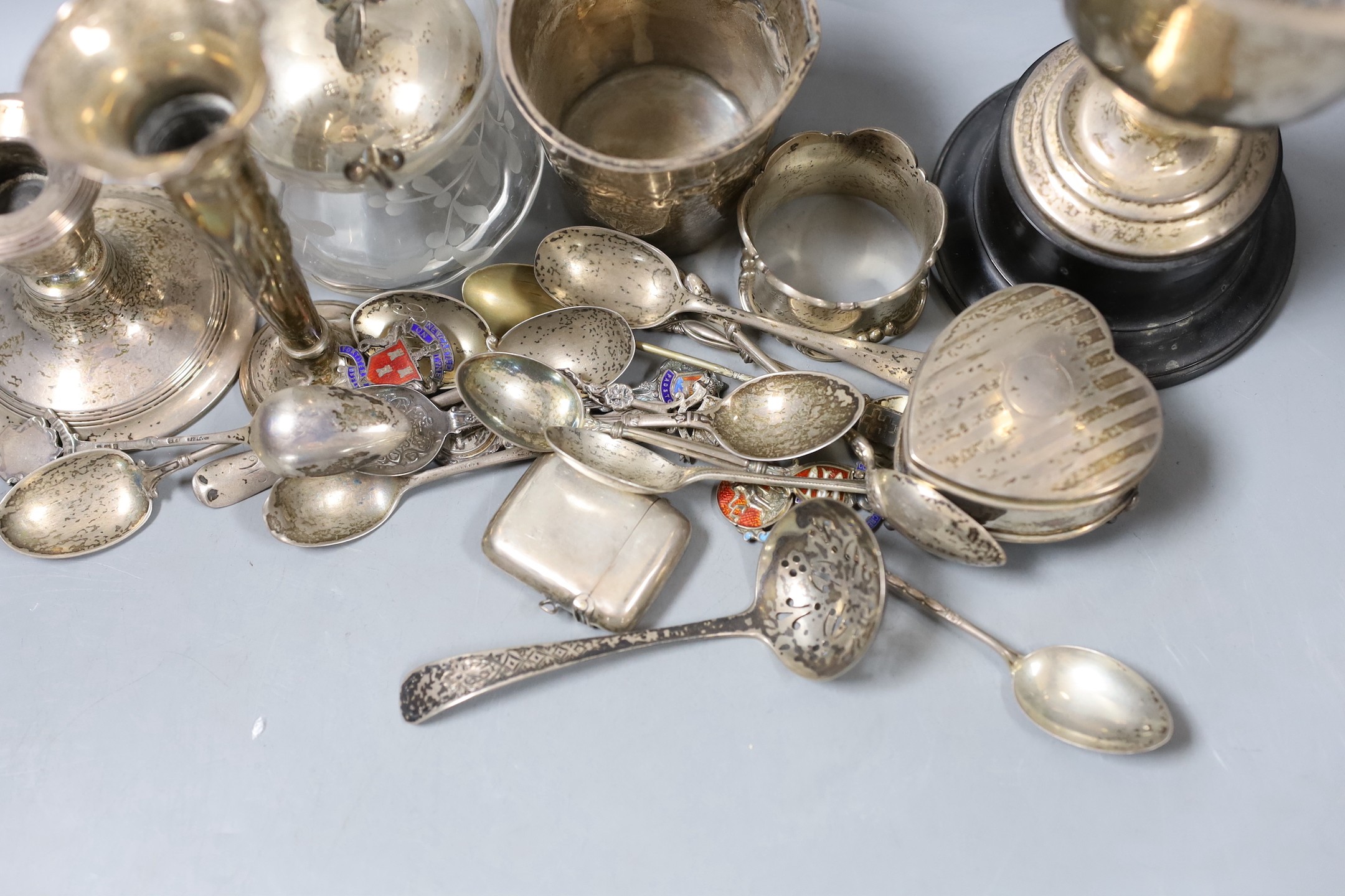 A collection of eighteen small pieces of silver and white metal items, including a silver topped glass preserve jar, trophy cup, flatware, napkin ring, trinket box, etc.